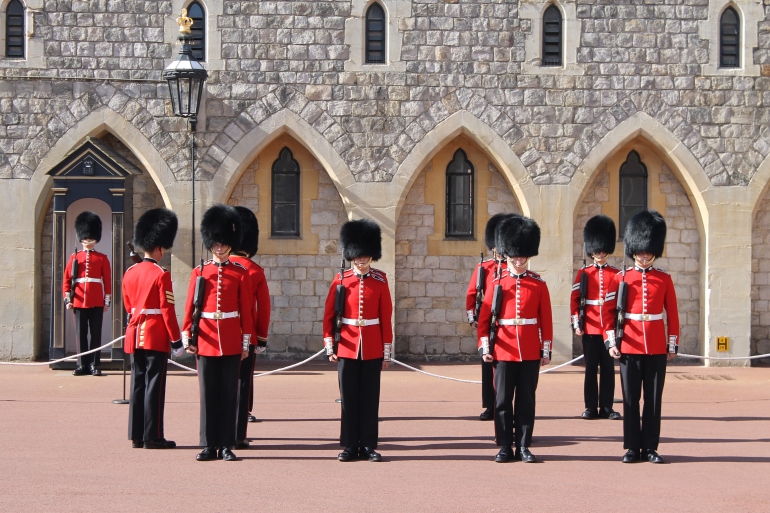 The Windsor Castle guards proceed in a changing of the guard ceremony.